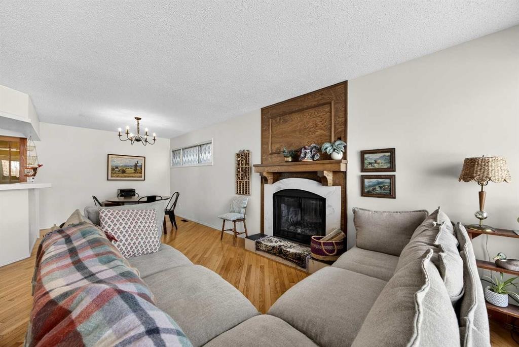 100 Strathcona Close Sw, Calgary, AB - Indoor Photo Showing Living Room With Fireplace