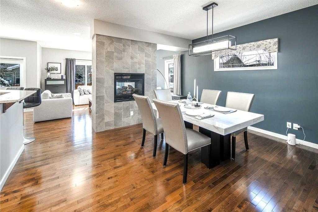5 Panatella Square Nw, Calgary, AB - Indoor Photo Showing Dining Room With Fireplace