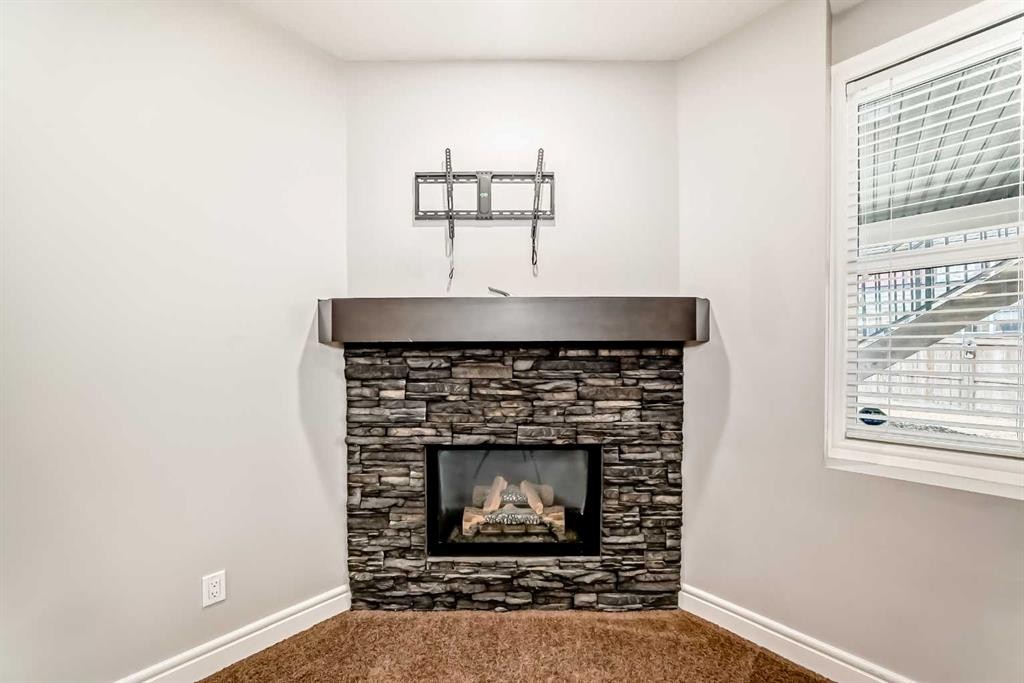 7904 Masters Boulevard Se, Calgary, AB - Indoor Photo Showing Living Room With Fireplace