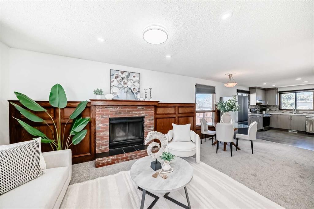 6735 Temple Drive Ne, Calgary, AB - Indoor Photo Showing Living Room With Fireplace