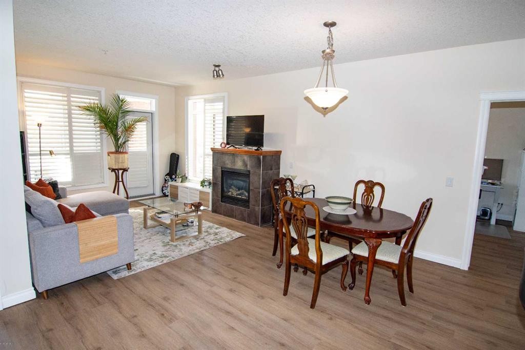 208-10 Hemlock Crescent Sw, Calgary, AB - Indoor Photo Showing Other Room With Fireplace