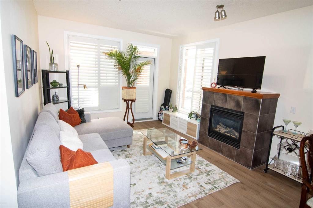 208-10 Hemlock Crescent Sw, Calgary, AB - Indoor Photo Showing Living Room With Fireplace