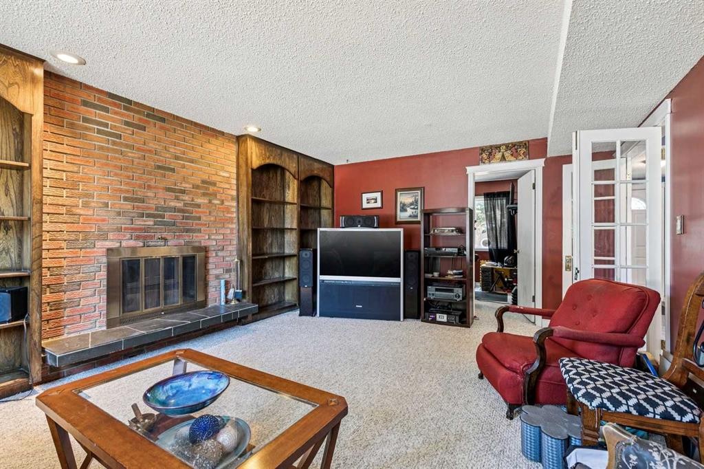 443 Brookmere Crescent Sw, Calgary, AB - Indoor Photo Showing Living Room With Fireplace