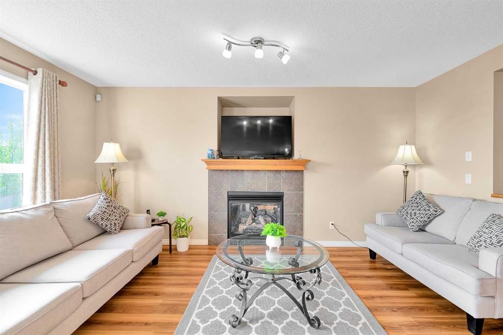 320 Evermeadow Road Sw, Calgary, AB - Indoor Photo Showing Living Room With Fireplace