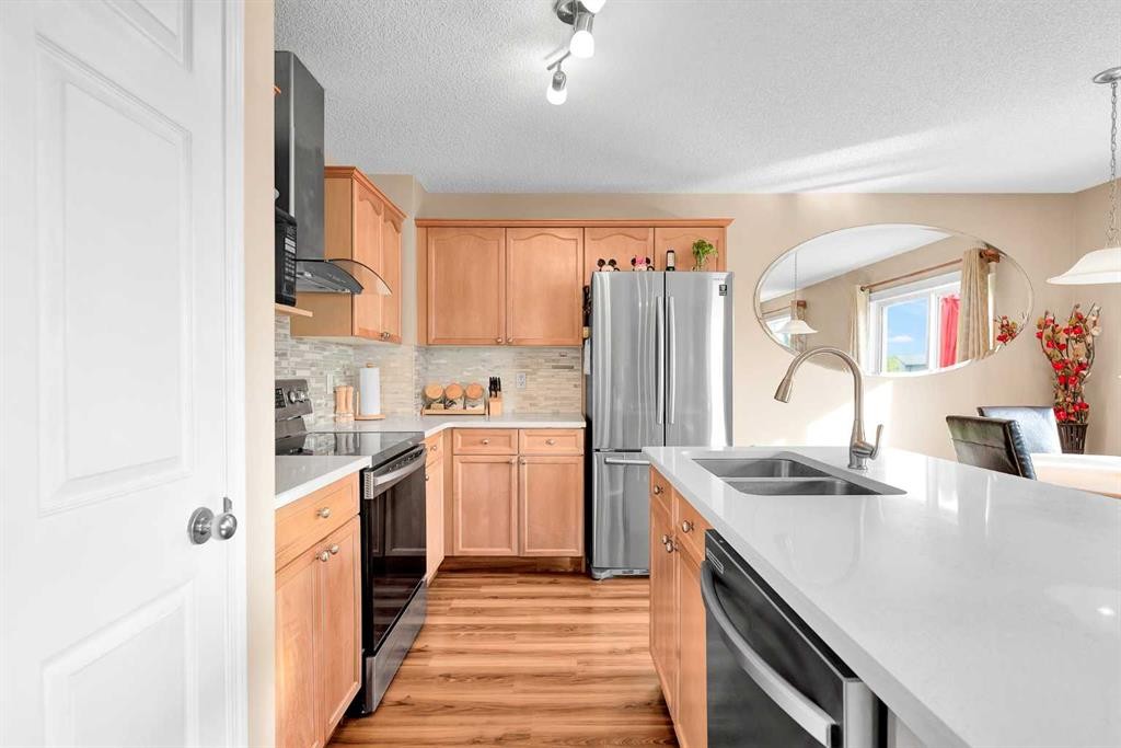 320 Evermeadow Road Sw, Calgary, AB - Indoor Photo Showing Kitchen With Stainless Steel Kitchen With Double Sink