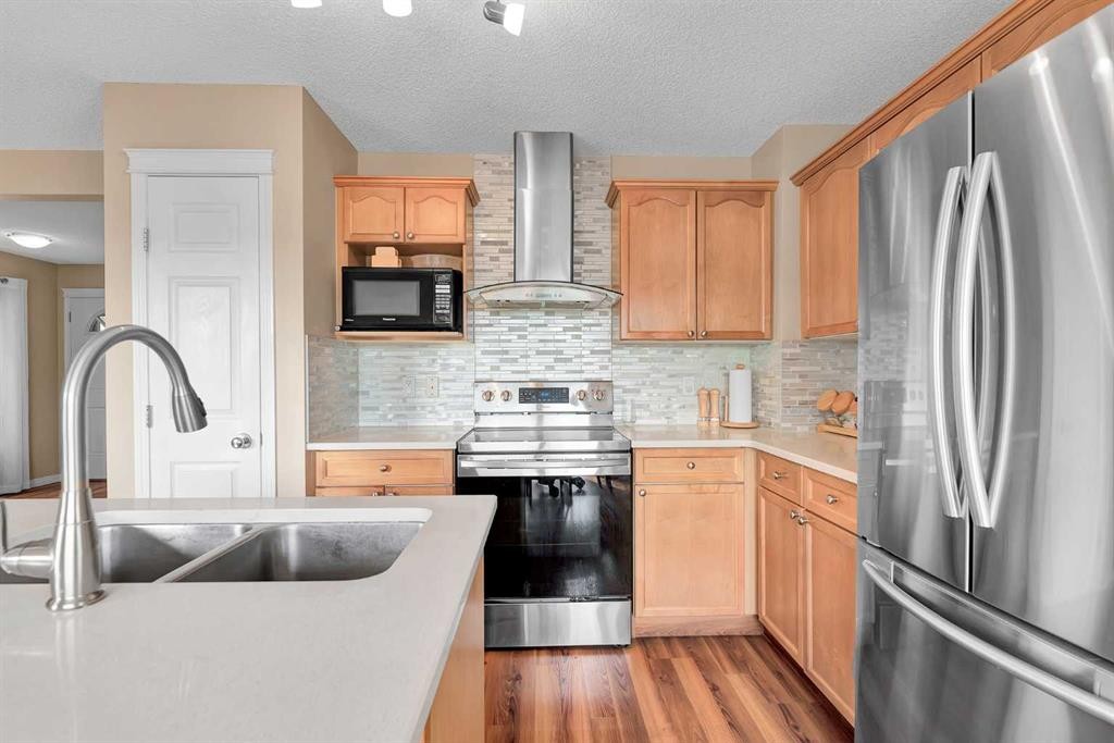 320 Evermeadow Road Sw, Calgary, AB - Indoor Photo Showing Kitchen With Stainless Steel Kitchen With Double Sink