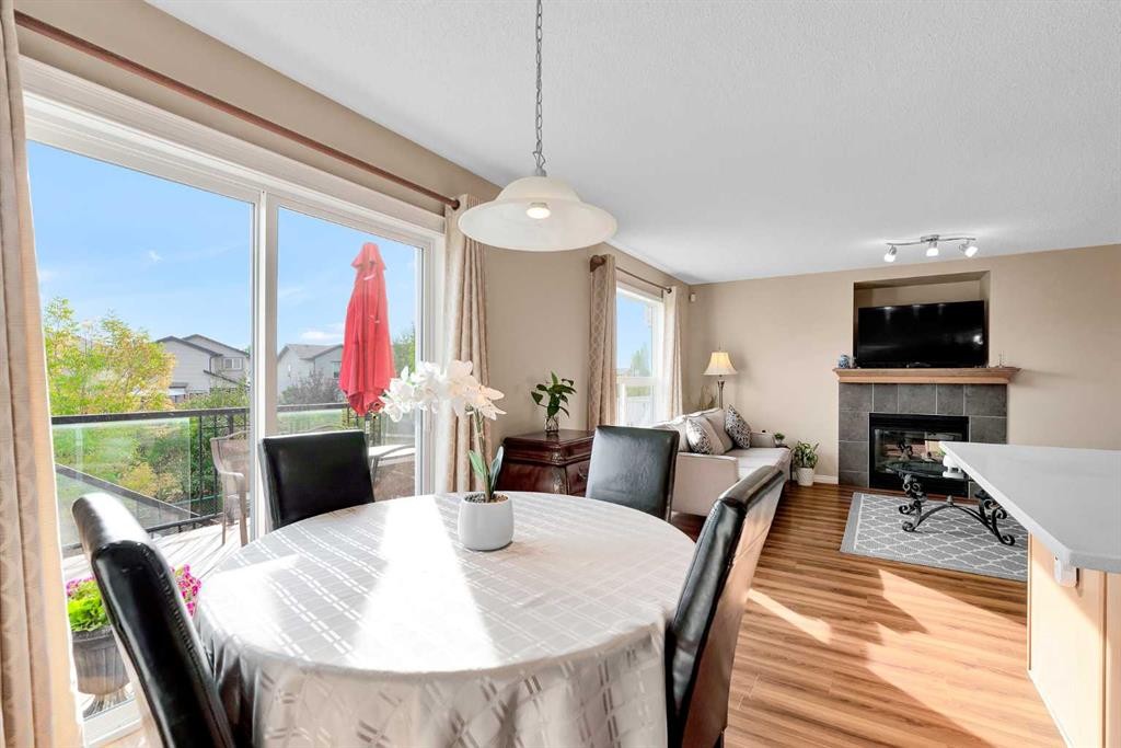 320 Evermeadow Road Sw, Calgary, AB - Indoor Photo Showing Dining Room With Fireplace
