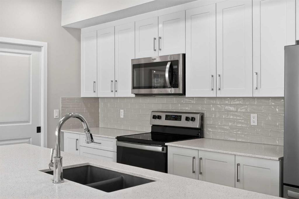 214-140 Mahogany Street Se, Calgary, AB - Indoor Photo Showing Kitchen With Stainless Steel Kitchen With Double Sink With Upgraded Kitchen