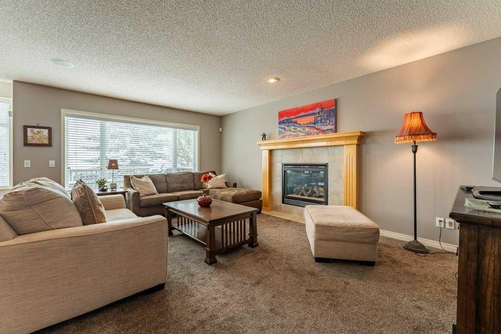 62 Springbluff Boulevard Sw, Calgary, AB - Indoor Photo Showing Living Room With Fireplace