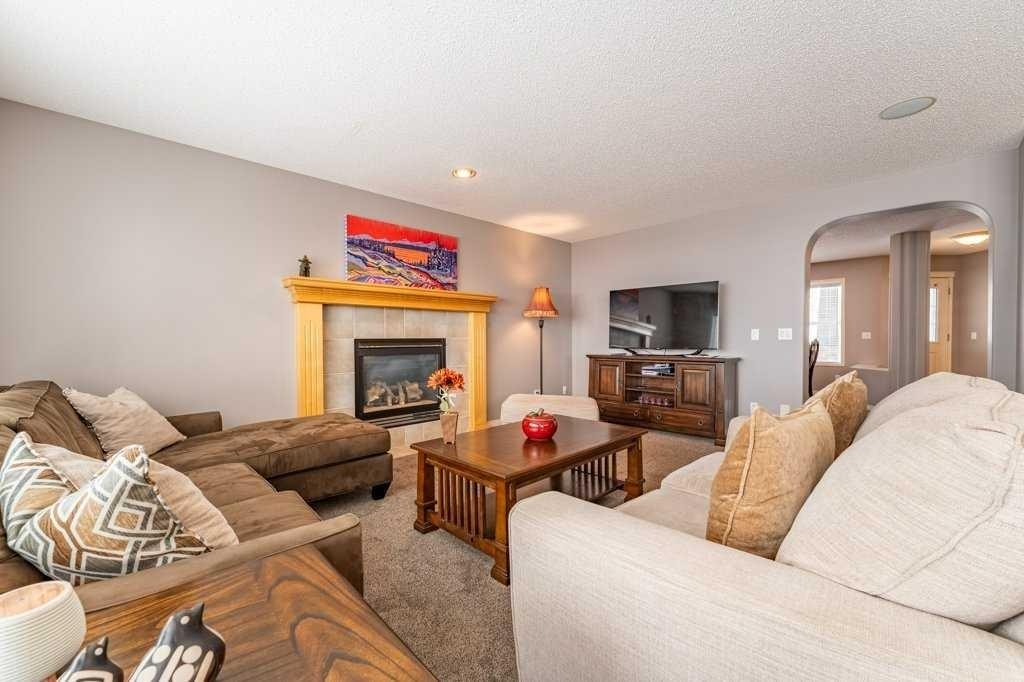 62 Springbluff Boulevard Sw, Calgary, AB - Indoor Photo Showing Living Room With Fireplace
