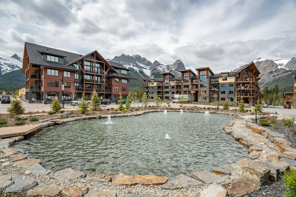 402-1505 Spring Creek Gate, Canmore, AB - Outdoor With Body Of Water With Facade