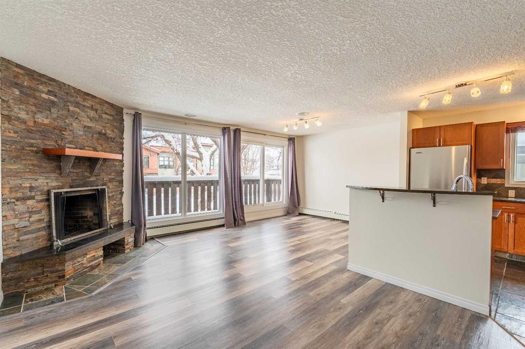 135 27 Avenue Ne, Calgary, AB - Indoor Photo Showing Other Room With Fireplace