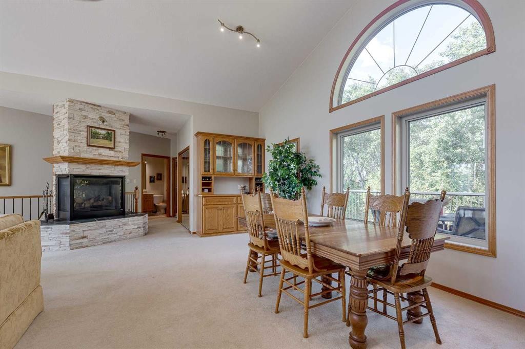 602 Pheasant Close, Pelican Point, AB - Indoor Photo Showing Dining Room With Fireplace