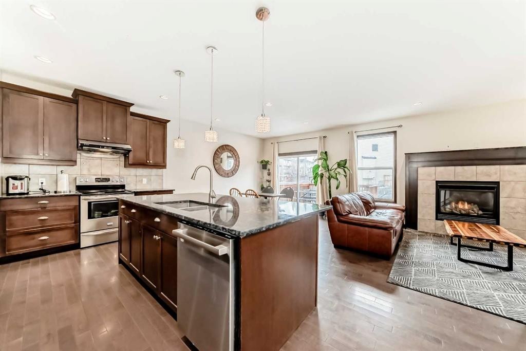 691 Panamount Boulevard Nw, Calgary, AB - Indoor Photo Showing Kitchen With Fireplace With Stainless Steel Kitchen With Upgraded Kitchen