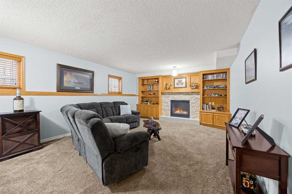 1331 Sunvista Way Se, Calgary, AB - Indoor Photo Showing Living Room With Fireplace
