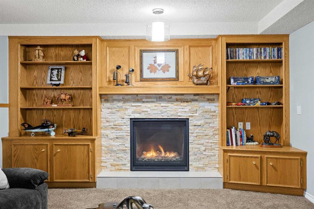 1331 Sunvista Way Se, Calgary, AB - Indoor Photo Showing Living Room With Fireplace