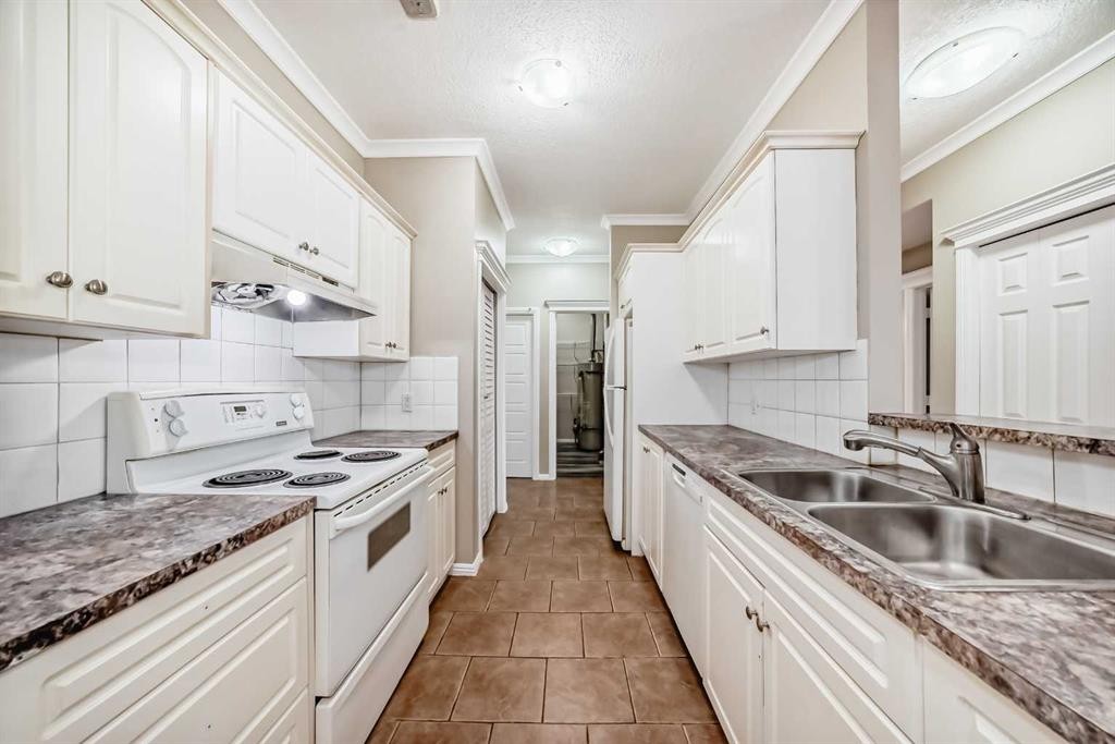 205-7 Lineham Avenue, Okotoks, AB - Indoor Photo Showing Kitchen With Double Sink
