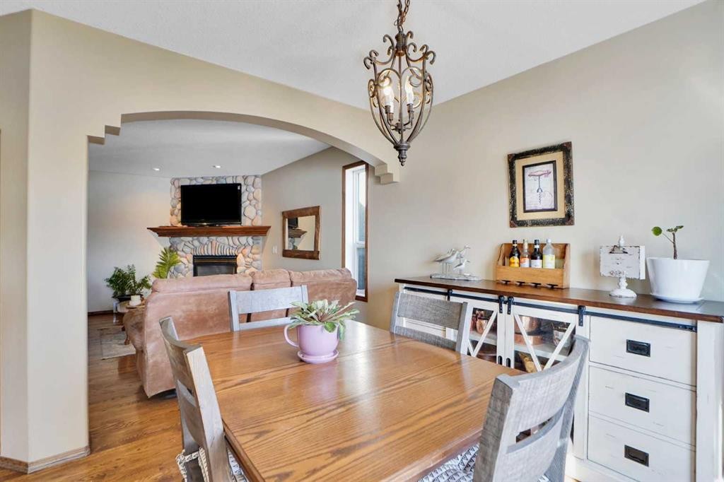 32 Harvest Park Way Ne, Calgary, AB - Indoor Photo Showing Dining Room With Fireplace