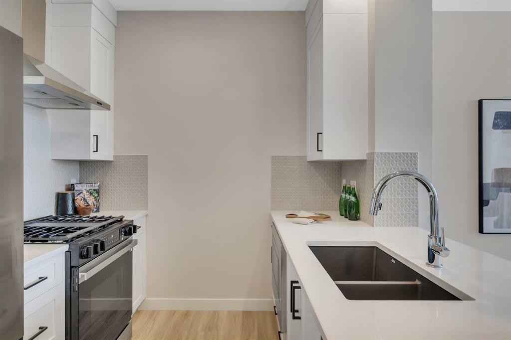 1047 Bayview Crescent, Airdrie, AB - Indoor Photo Showing Kitchen With Double Sink