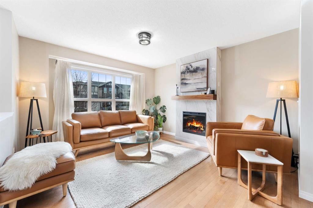 100 Evansborough Common Nw, Calgary, AB - Indoor Photo Showing Living Room With Fireplace