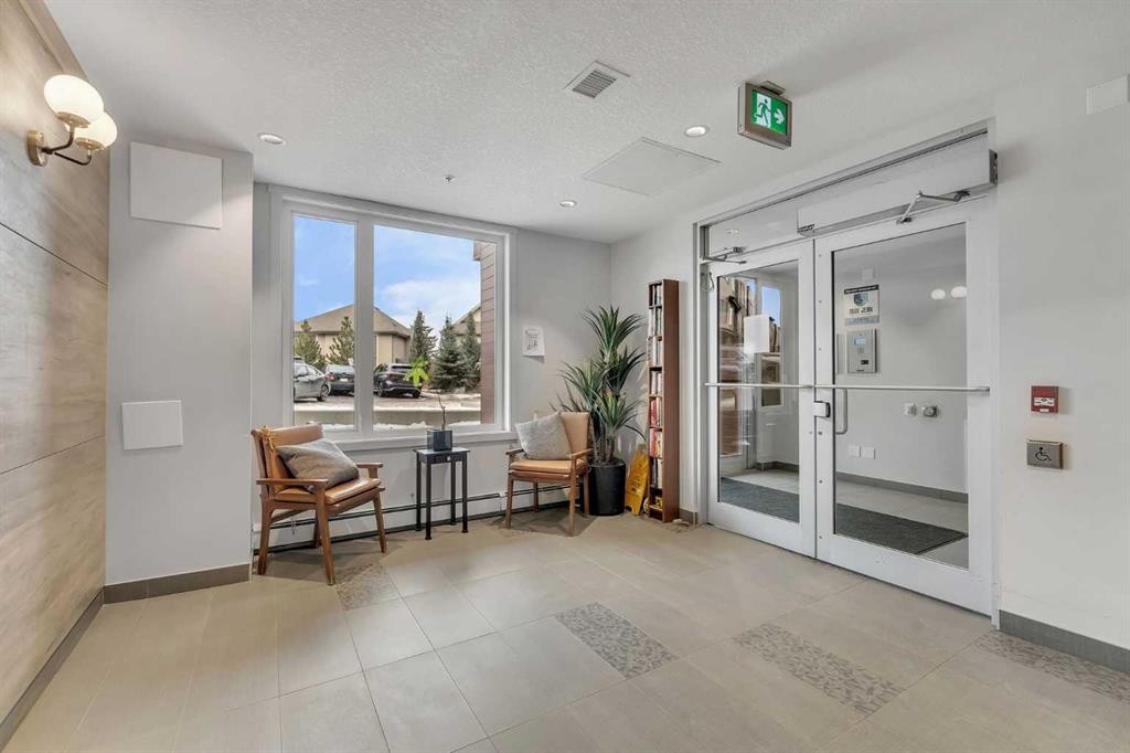 301-71 Shawnee Common Sw, Calgary, AB - Indoor Photo Showing Other Room