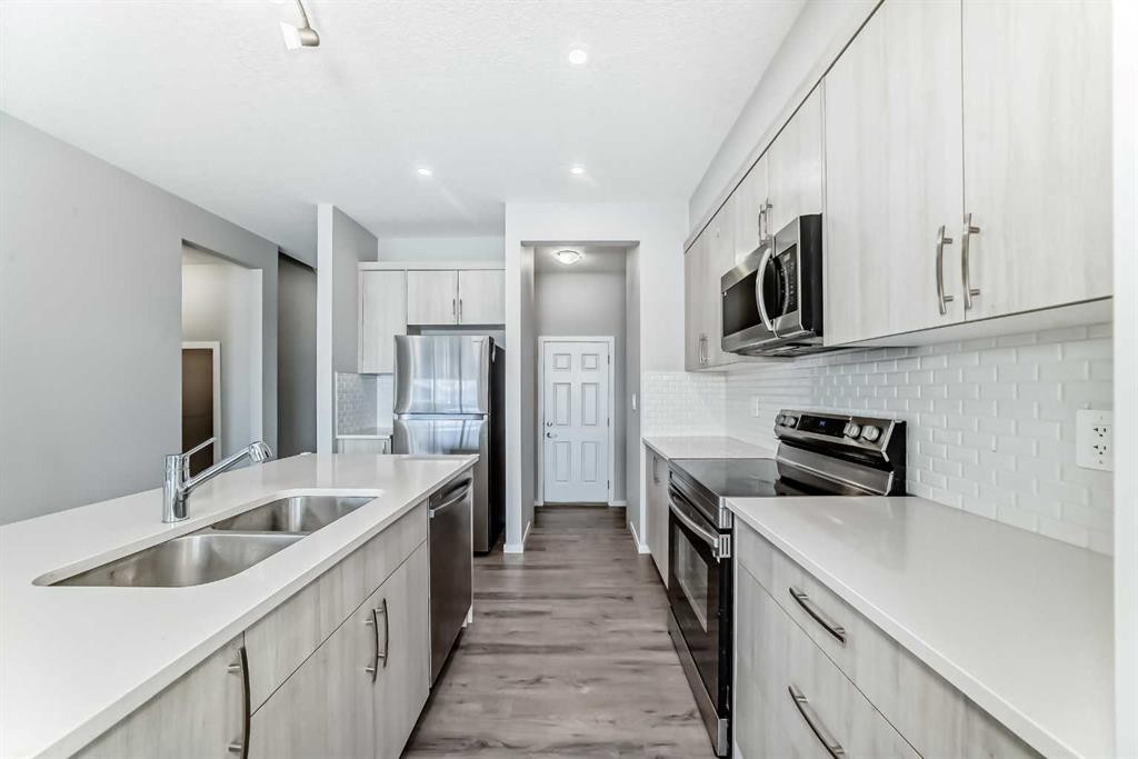 224 Carringham Way Nw, Calgary, AB - Indoor Photo Showing Kitchen With Stainless Steel Kitchen With Double Sink With Upgraded Kitchen