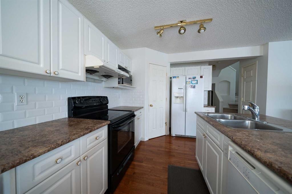 11 Arbour Stone Crescent Nw, Calgary, AB - Indoor Photo Showing Kitchen With Double Sink