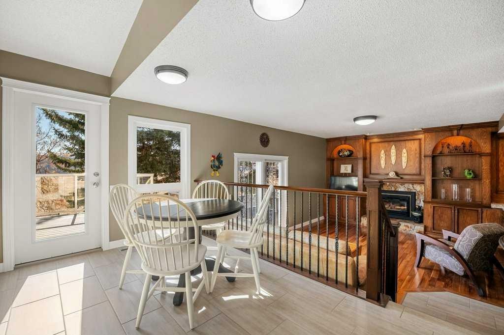 44 Deerbrook Crescent Se, Calgary, AB - Indoor Photo Showing Dining Room With Fireplace