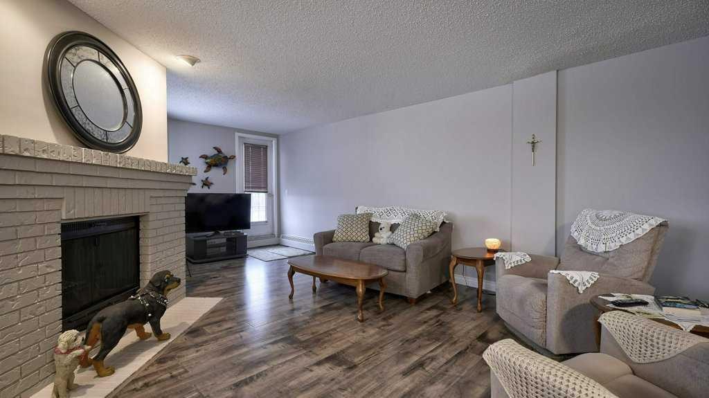324-2425 90 Avenue Sw, Calgary, AB - Indoor Photo Showing Living Room With Fireplace