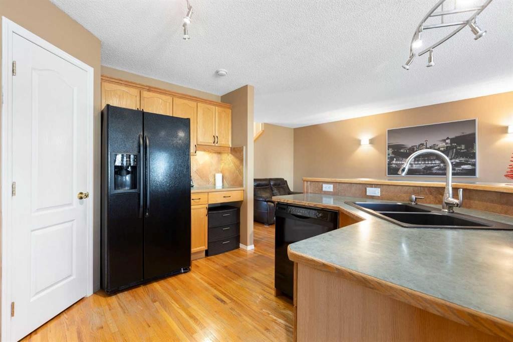 227 Bridlewood Circle Sw, Calgary, AB - Indoor Photo Showing Kitchen With Double Sink
