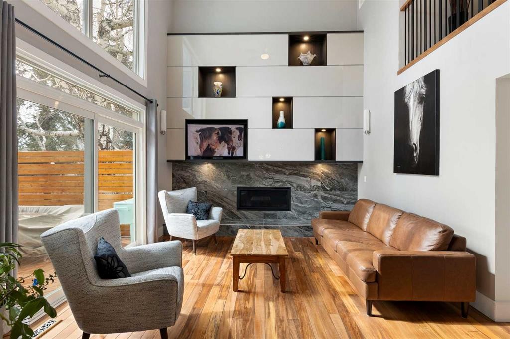 106 Shawnee Place Sw, Calgary, AB - Indoor Photo Showing Living Room With Fireplace
