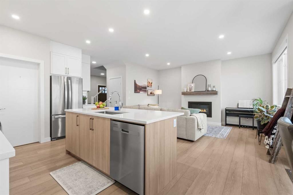 60 Ranchers View, Okotoks, AB - Indoor Photo Showing Kitchen With Fireplace With Stainless Steel Kitchen With Upgraded Kitchen