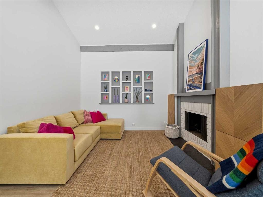 7723 Hunterview Drive Nw, Calgary, AB - Indoor Photo Showing Living Room With Fireplace