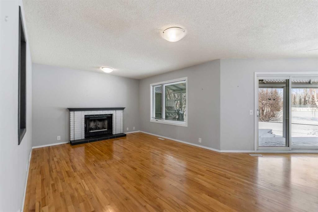 9 Mckenzie Place Se, Calgary, AB - Indoor Photo Showing Living Room With Fireplace