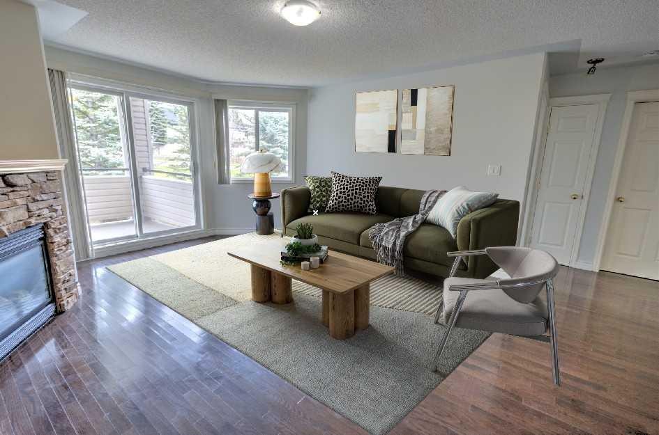 1207-7451 Springbank Boulevard Sw, Calgary, AB - Indoor Photo Showing Living Room With Fireplace