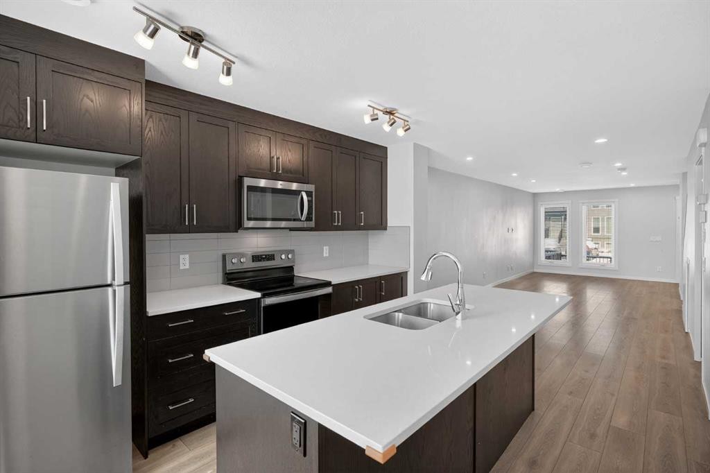 306-338 Seton Circle Se, Calgary, AB - Indoor Photo Showing Kitchen With Double Sink With Upgraded Kitchen