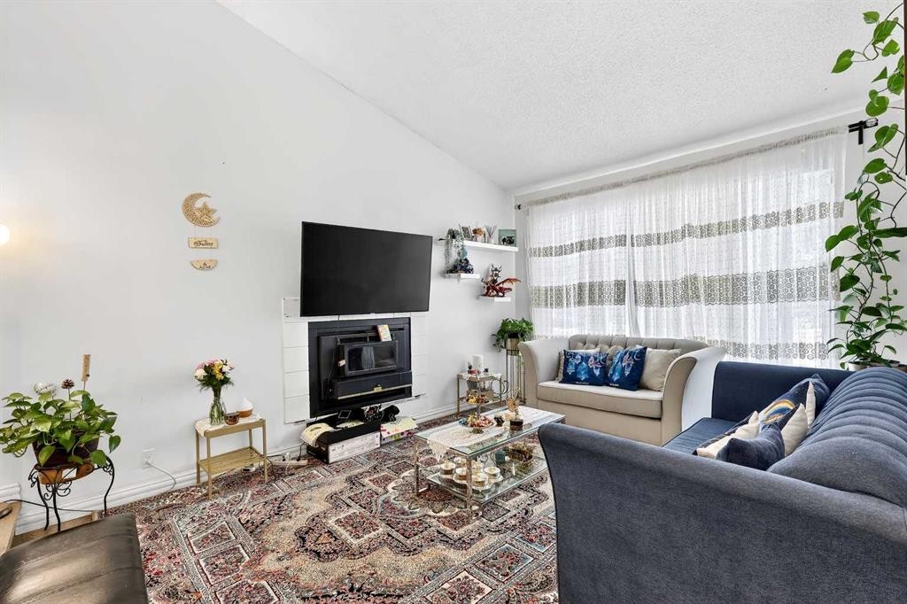 236 Mckerrell Way Se, Calgary, AB - Indoor Photo Showing Living Room With Fireplace