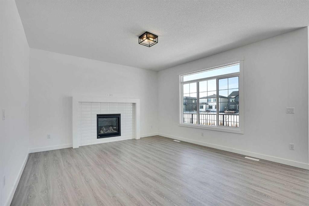 230 Kinniburgh Loop, Chestermere, AB - Indoor Photo Showing Living Room With Fireplace