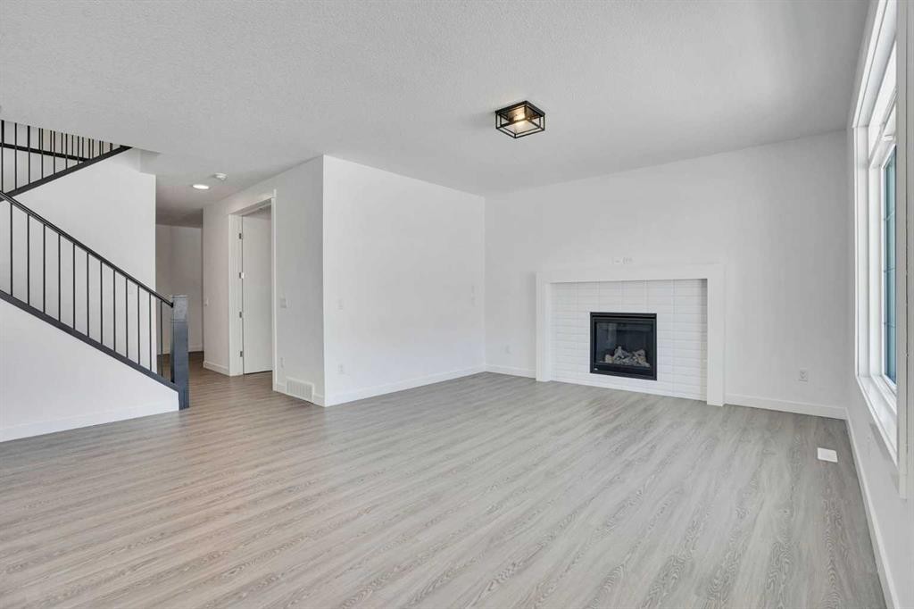 230 Kinniburgh Loop, Chestermere, AB - Indoor Photo Showing Living Room With Fireplace