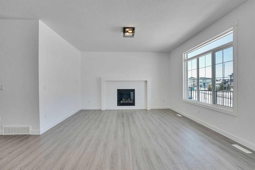230 Kinniburgh Loop, Chestermere, AB - Indoor Photo Showing Living Room With Fireplace