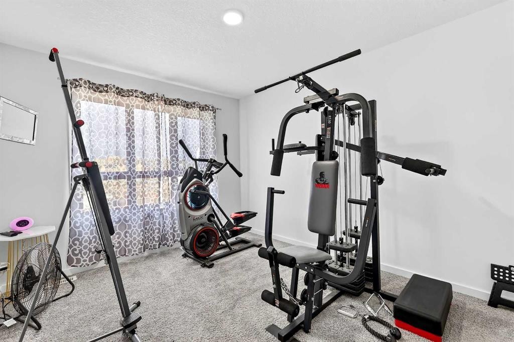42 Heirloom Manor Se, Calgary, AB - Indoor Photo Showing Gym Room