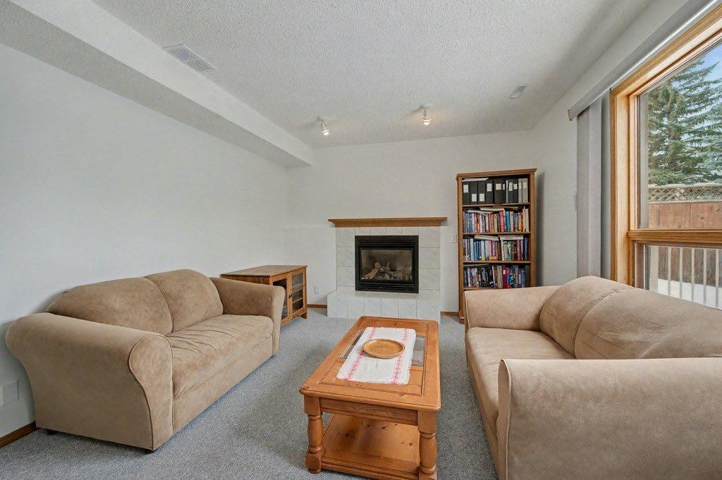 16 Straddock Crescent Sw, Calgary, AB - Indoor Photo Showing Living Room With Fireplace