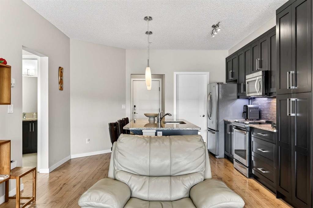 308-402 Marquis Lane Se, Calgary, AB - Indoor Photo Showing Kitchen With Stainless Steel Kitchen With Upgraded Kitchen