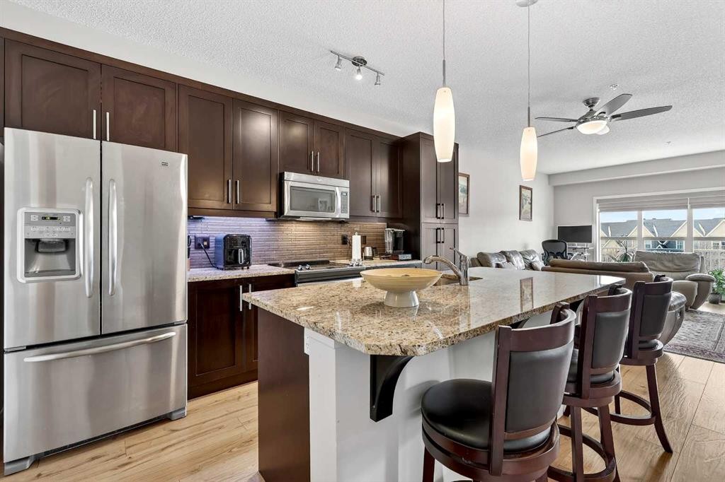 308-402 Marquis Lane Se, Calgary, AB - Indoor Photo Showing Kitchen With Stainless Steel Kitchen With Upgraded Kitchen