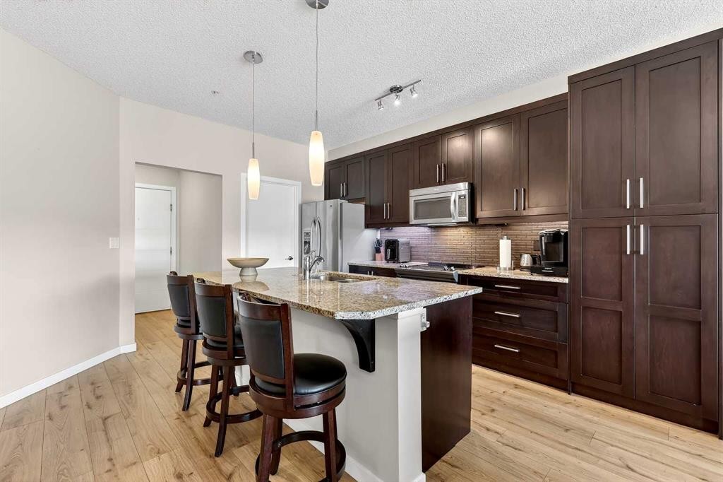 308-402 Marquis Lane Se, Calgary, AB - Indoor Photo Showing Kitchen With Stainless Steel Kitchen With Upgraded Kitchen