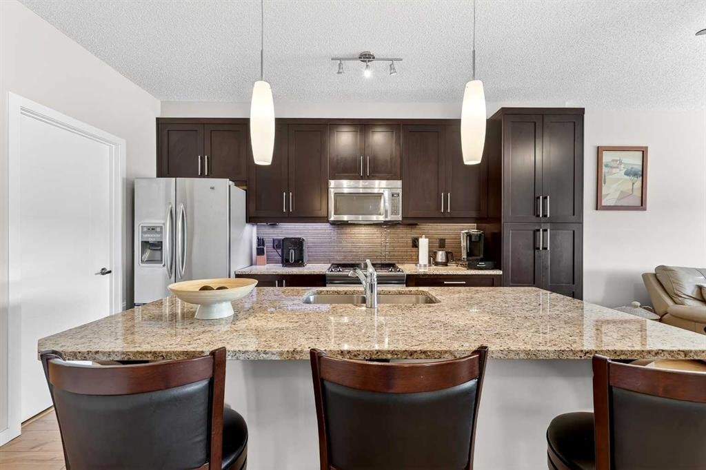 308-402 Marquis Lane Se, Calgary, AB - Indoor Photo Showing Kitchen With Stainless Steel Kitchen With Double Sink With Upgraded Kitchen