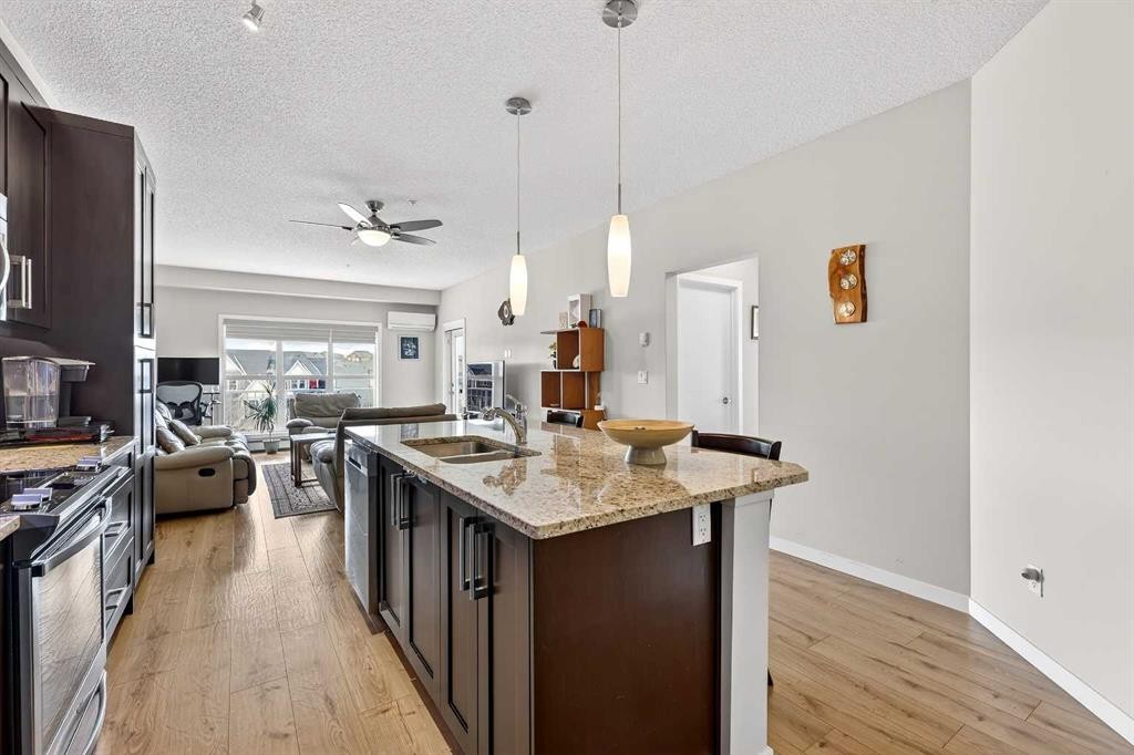 308-402 Marquis Lane Se, Calgary, AB - Indoor Photo Showing Kitchen With Double Sink With Upgraded Kitchen