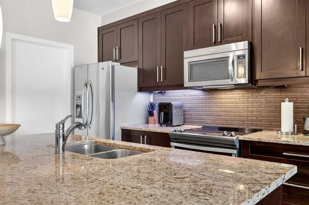 308-402 Marquis Lane Se, Calgary, AB - Indoor Photo Showing Kitchen With Double Sink With Upgraded Kitchen