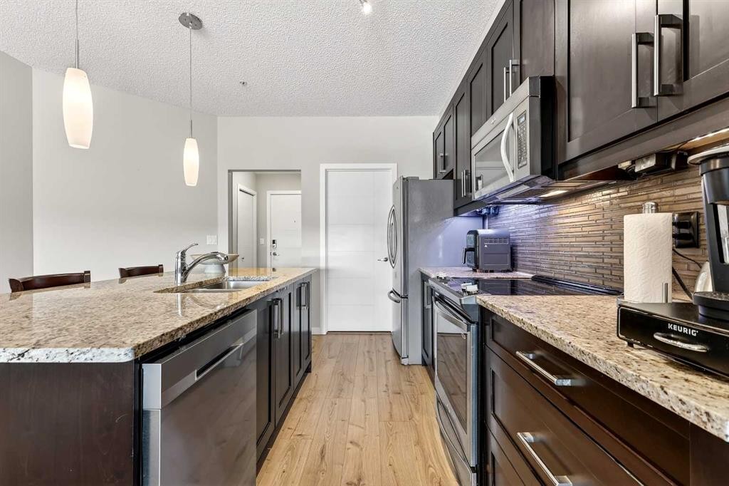 308-402 Marquis Lane Se, Calgary, AB - Indoor Photo Showing Kitchen With Stainless Steel Kitchen With Double Sink With Upgraded Kitchen