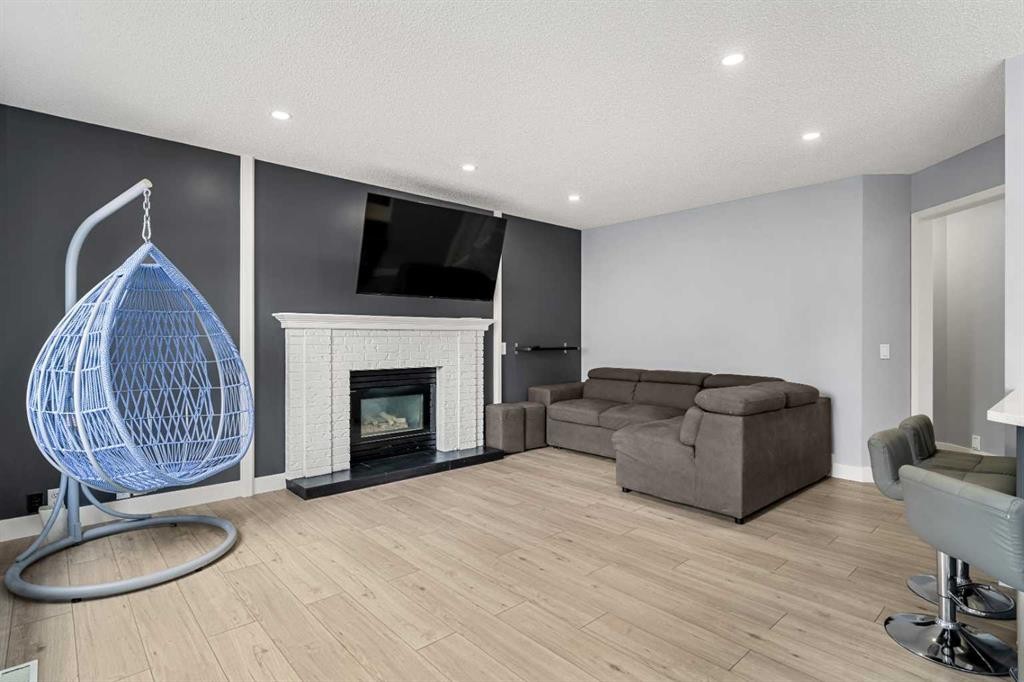 48 Douglas Park Boulevard Se, Calgary, AB - Indoor Photo Showing Living Room With Fireplace